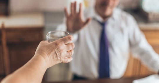 Man holding up his hand, refusing a drink